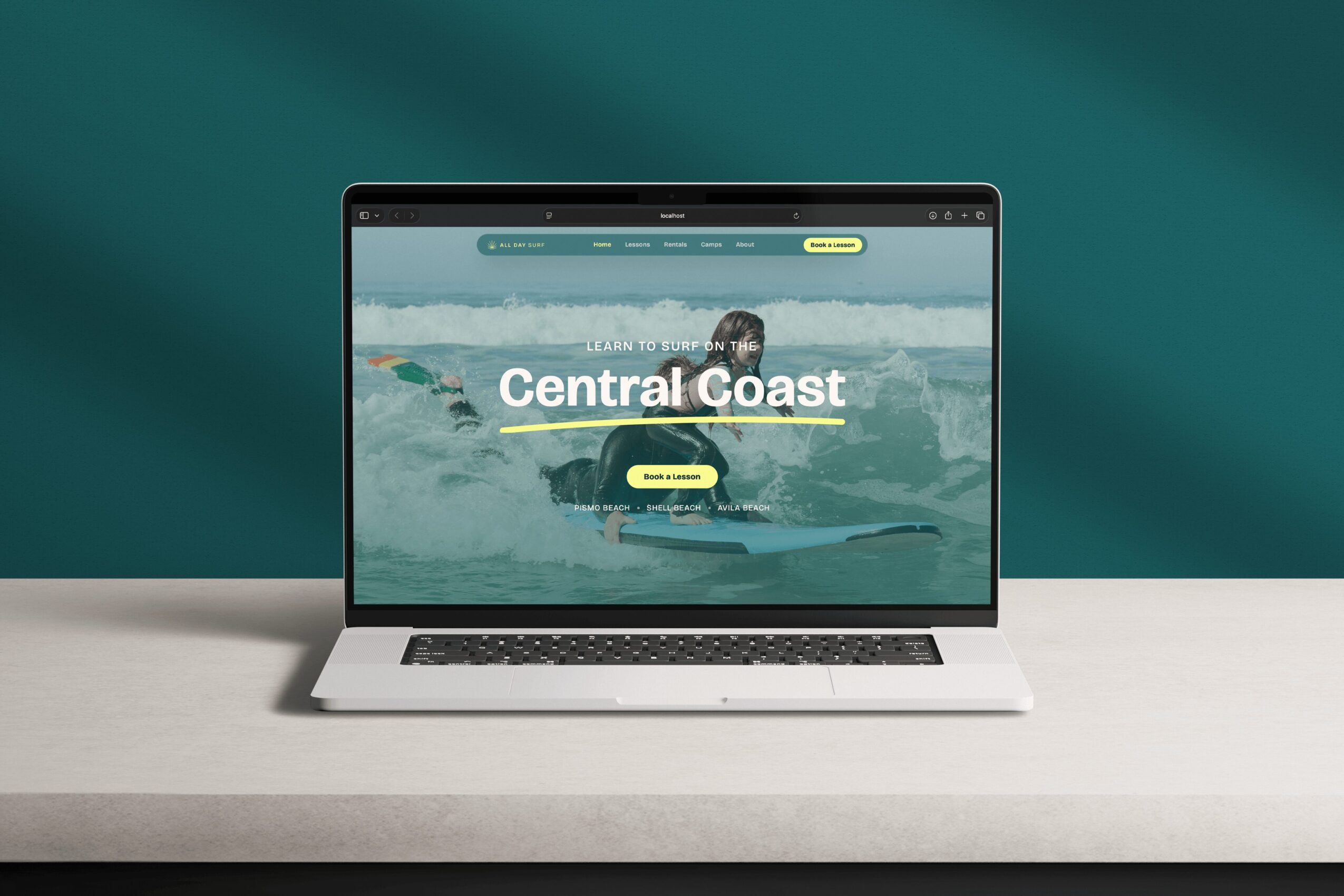 Laptop displaying a website with a person kayaking on water, text reads 'Central Coast', with a yellow button below.