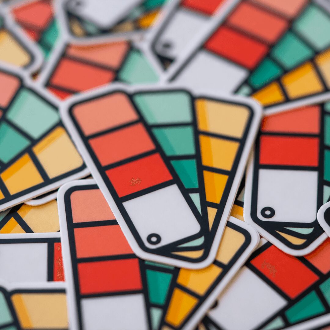 Multiple colorful UNO cards with red, yellow, green, and black colors overlapping each other.
