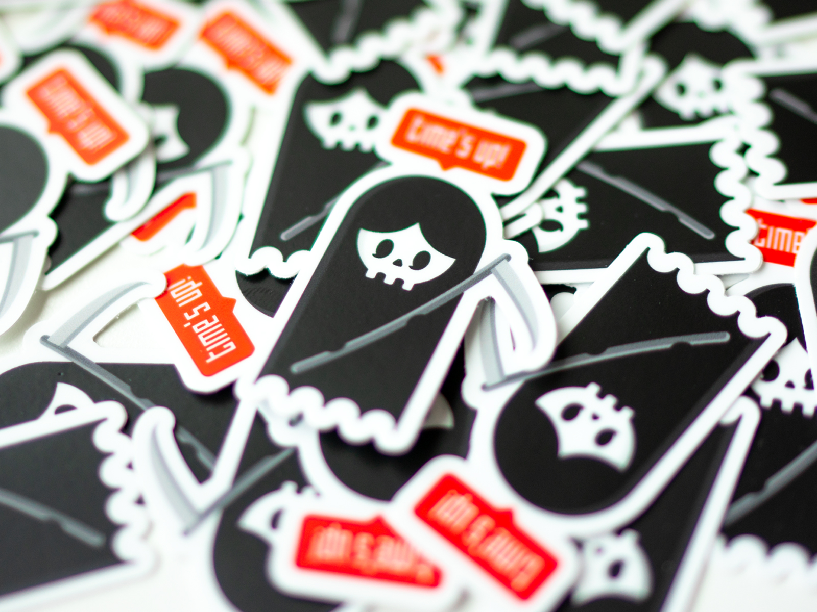 Collection of black and white stickers with skull and ghost images, some with red text, scattered randomly.