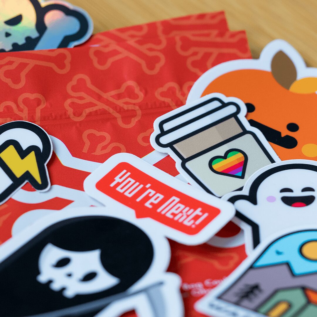Collection of colorful stickers with various designs, including a coffee cup with a rainbow heart, a smiling cloud, and a speech bubble saying 