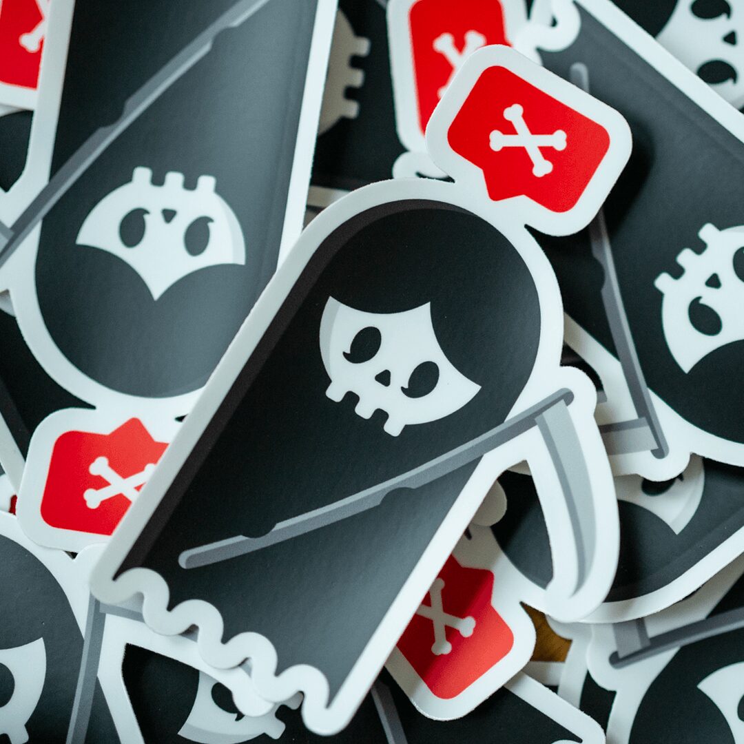 Collection of stickers with a skull and sword design, some with a red background and a white crossed bones symbol.