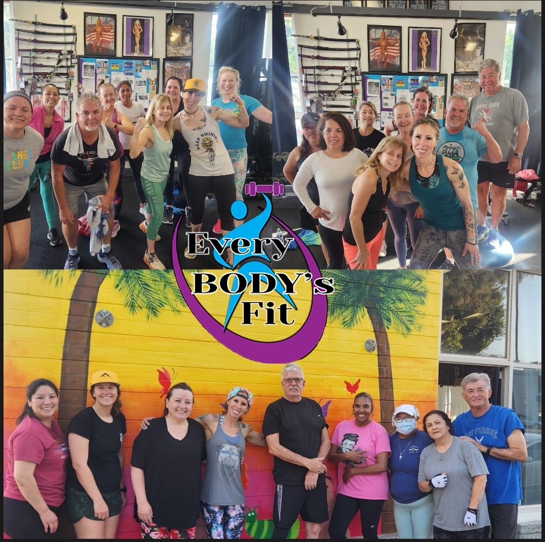 Group of people in a fitness class, smiling, in a gym with fitness equipment and colorful backgrounds.