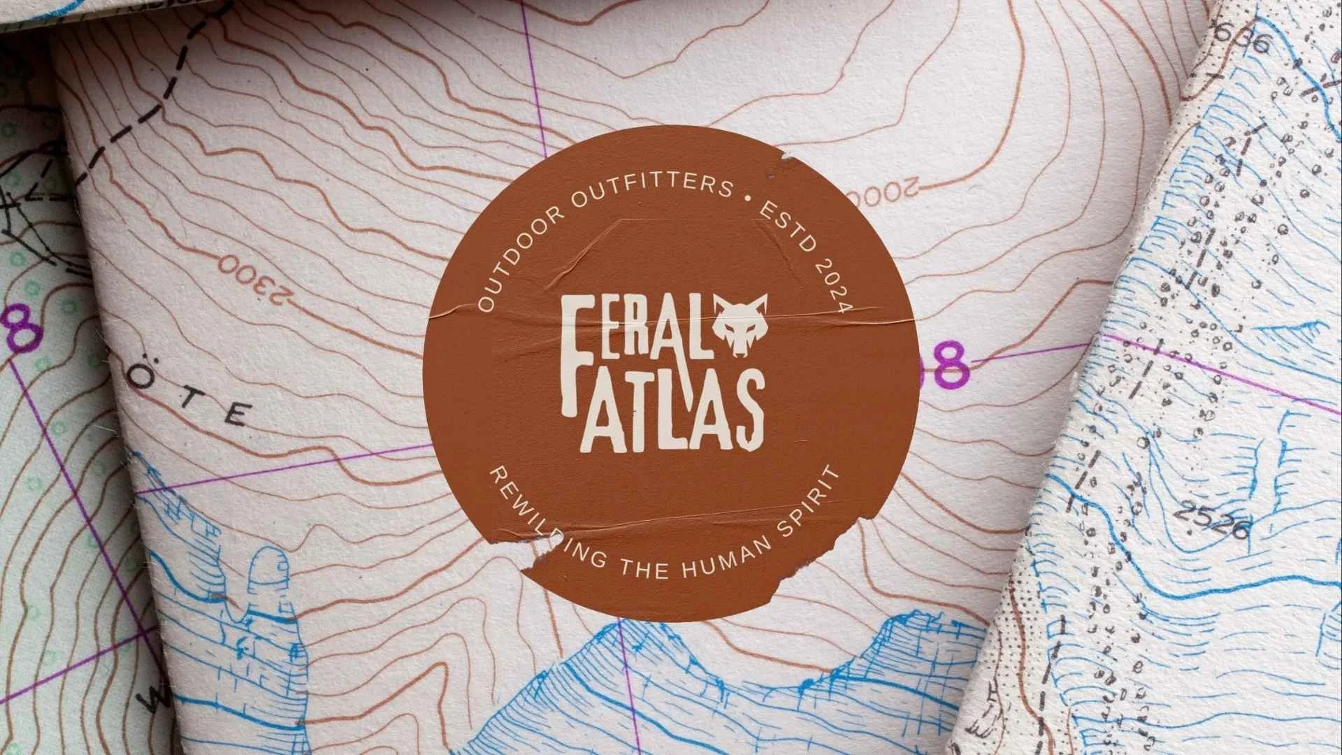 Close-up of a map with a circular logo reading 'Ebral Atlas' and 'Reviewing the Human Spirit.'