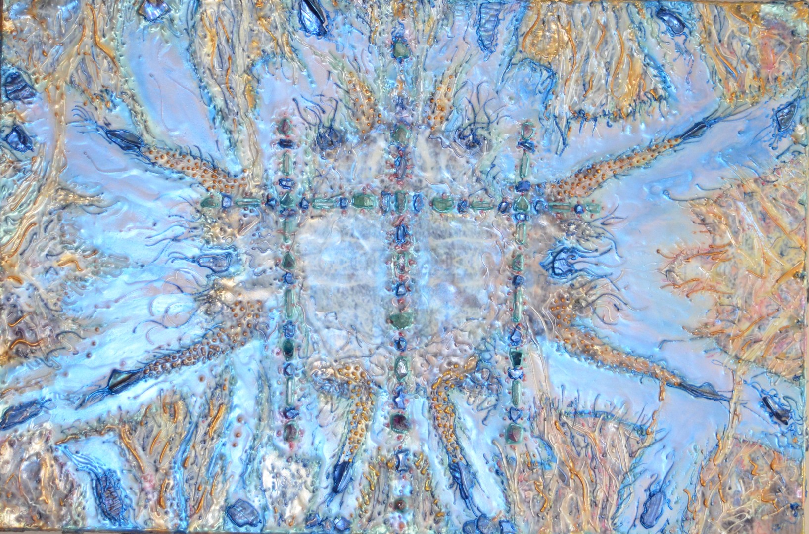 Abstract pattern with blue, gold, and beige colors, symmetrical design resembling a butterfly or insect wings.