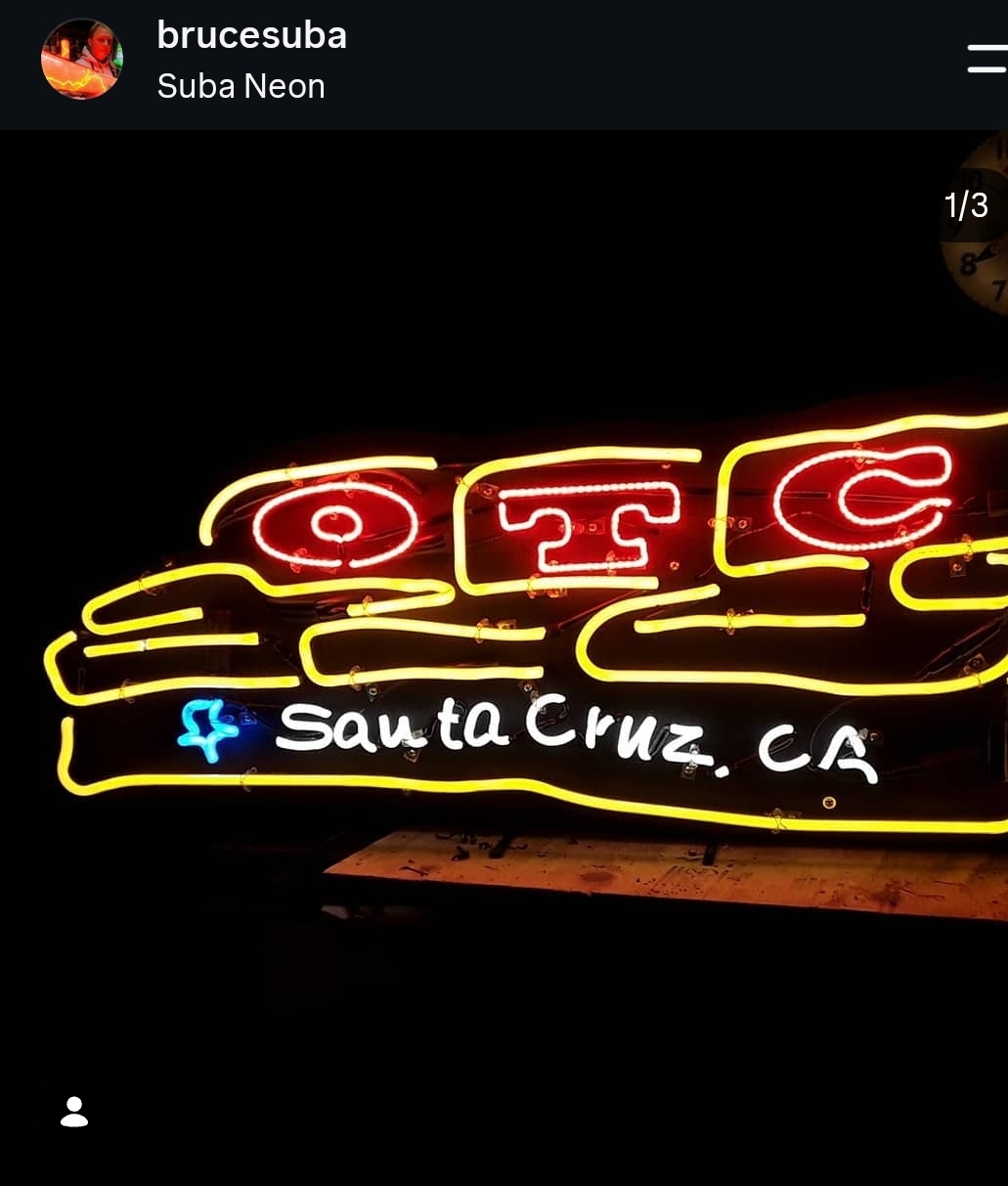 Neon sign with red and yellow lights displaying 'OTC' and 'Santa Cruz, CA' in white, against a black background.