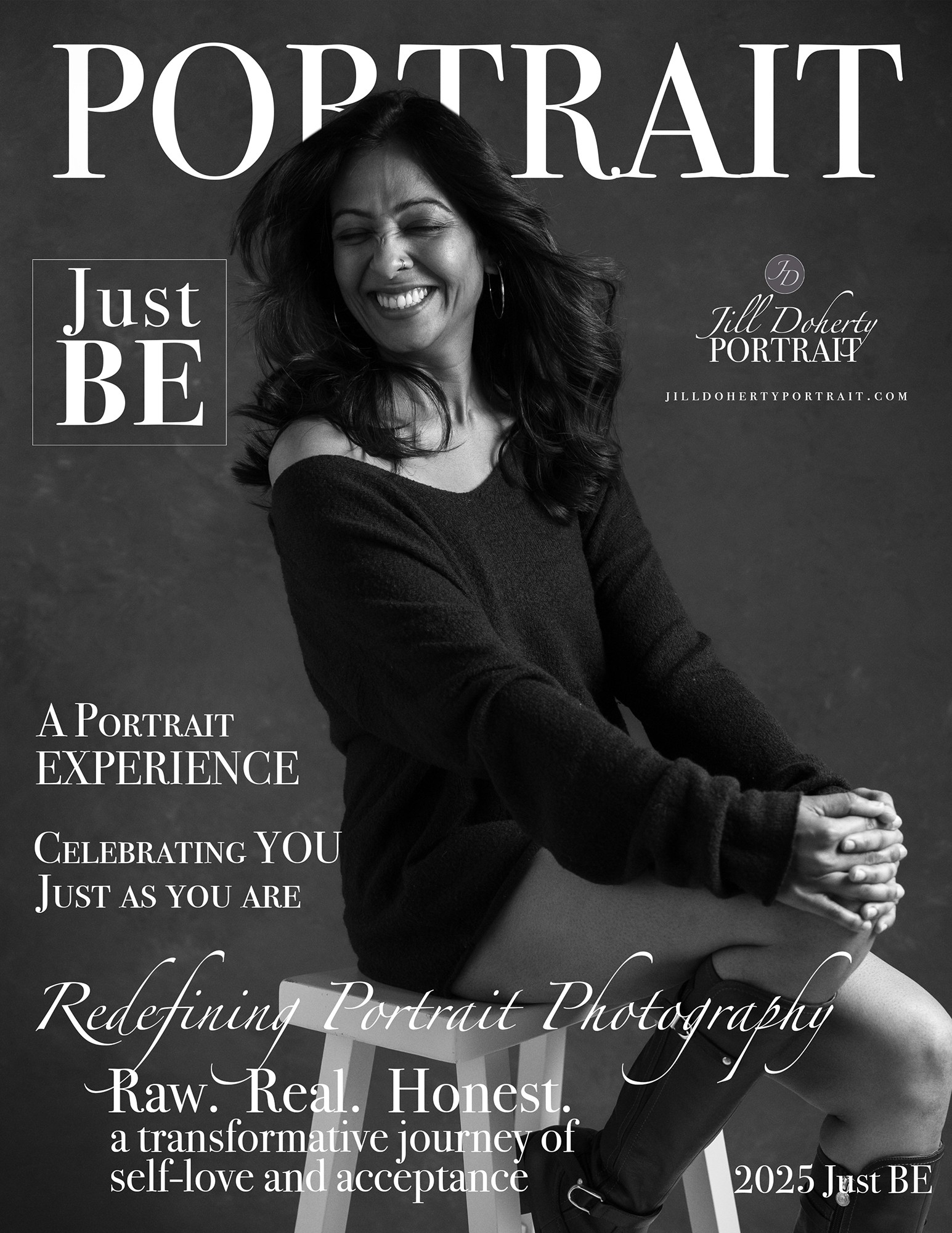 Black and white portrait of a smiling woman with long hair, wearing a dark top, sitting with crossed arms.
