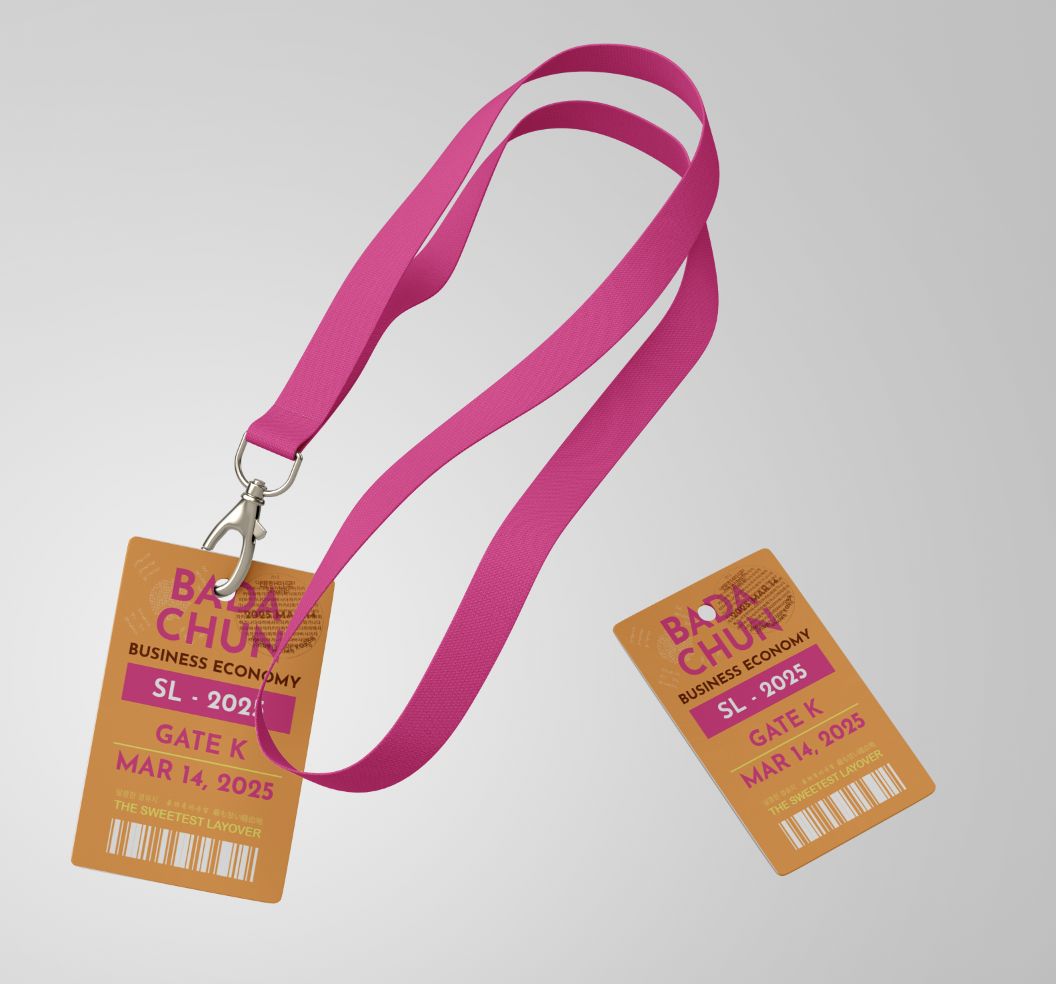 Two pink lanyards with event badges attached, lying on a light gray surface.