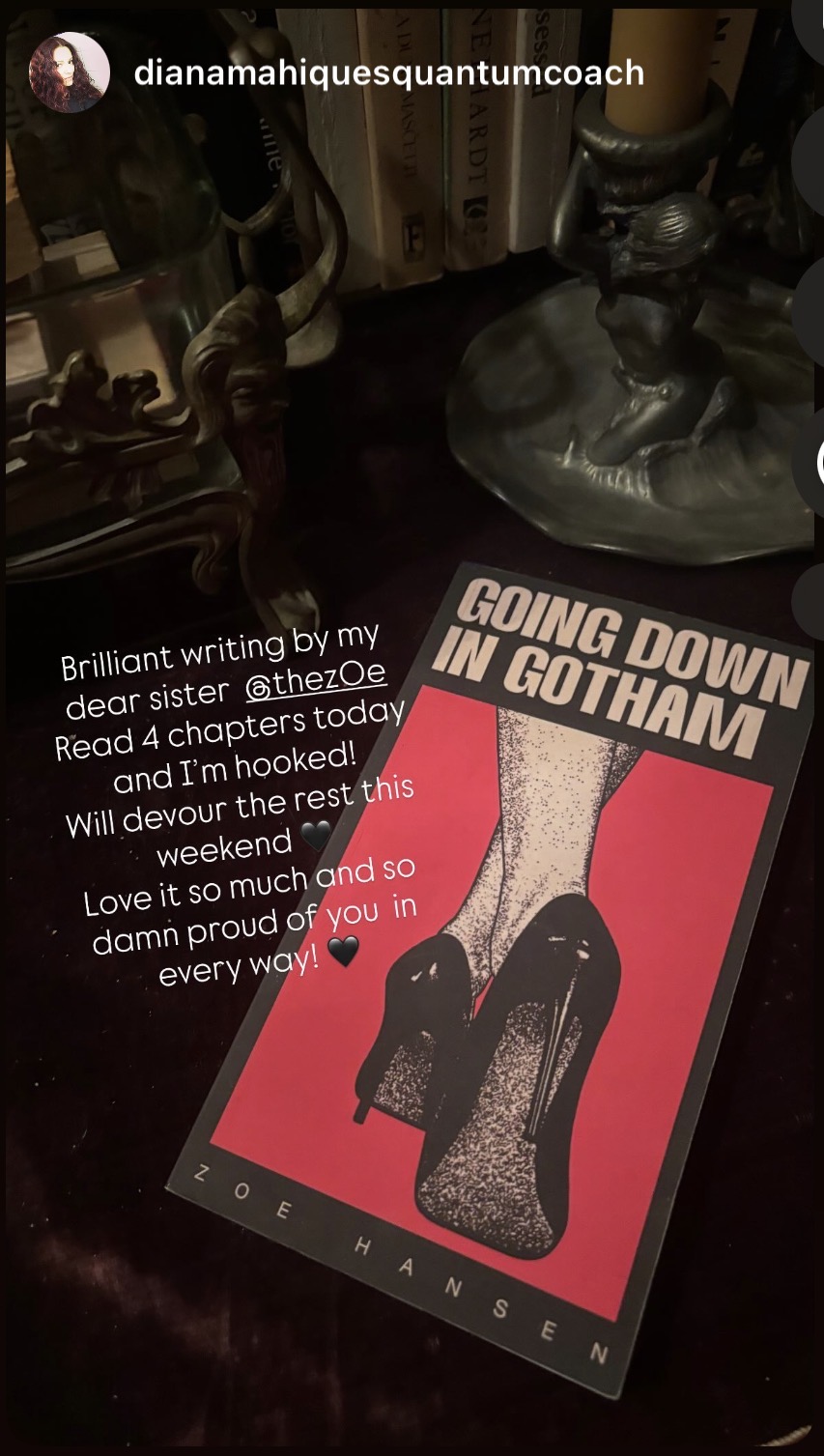 A table with decorative objects and a poster of high-heeled shoes with text about Gotham City, with a dark background.