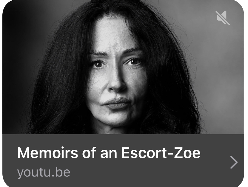 Black and white portrait of a woman with long dark hair, looking directly at the camera with a serious expression.