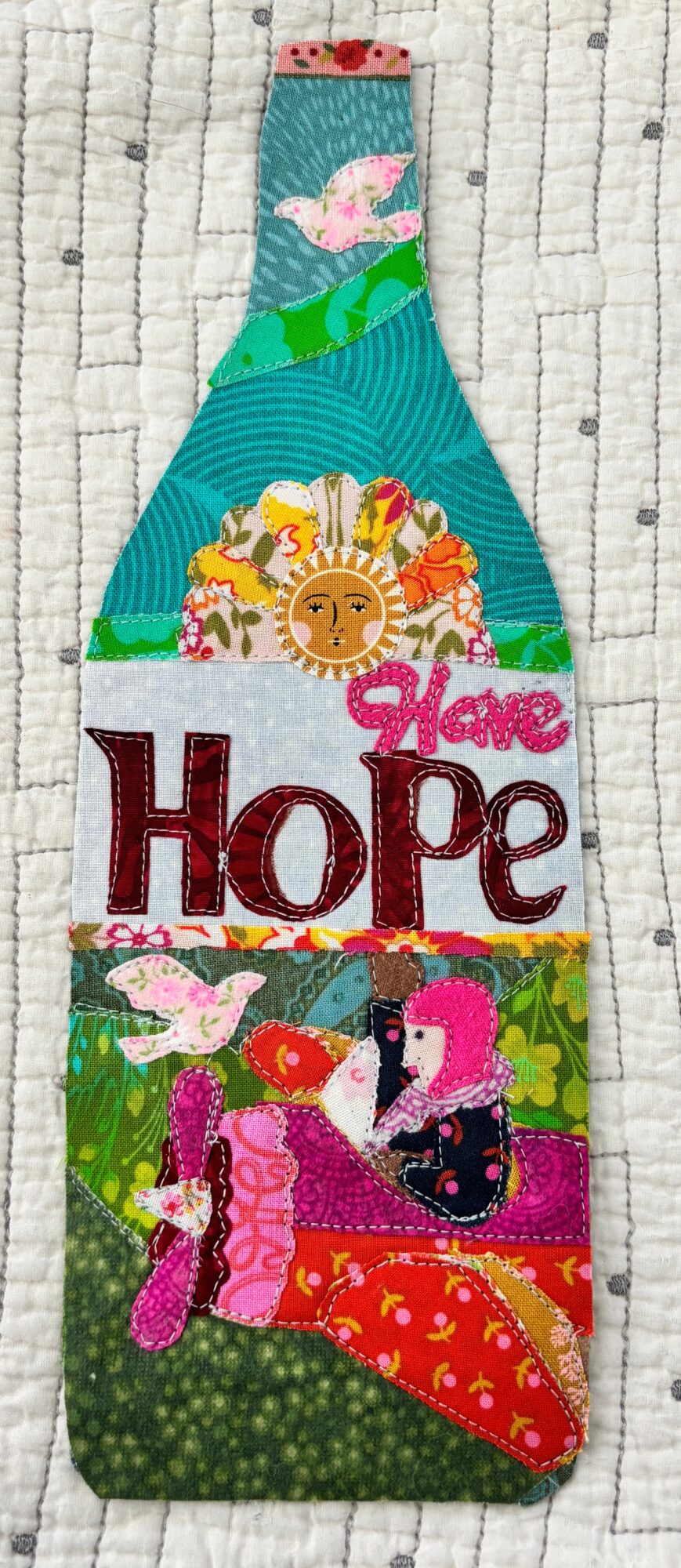 Colorful towel with a whale, sun, flamingos, and the words 'Hope' and 'Love' on a textured background.