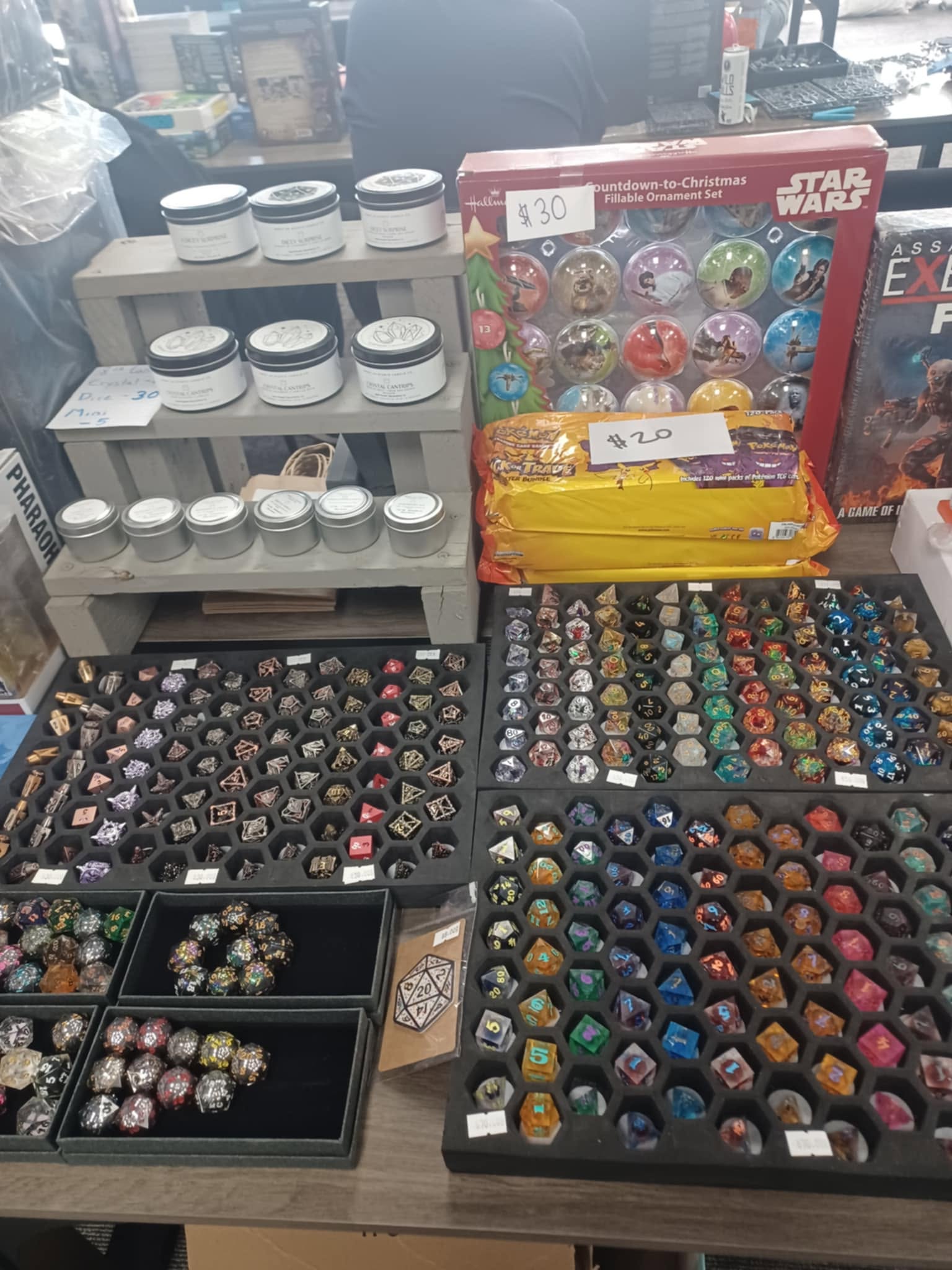 Display of various collectible items including rings, toys, and game boxes on a table.