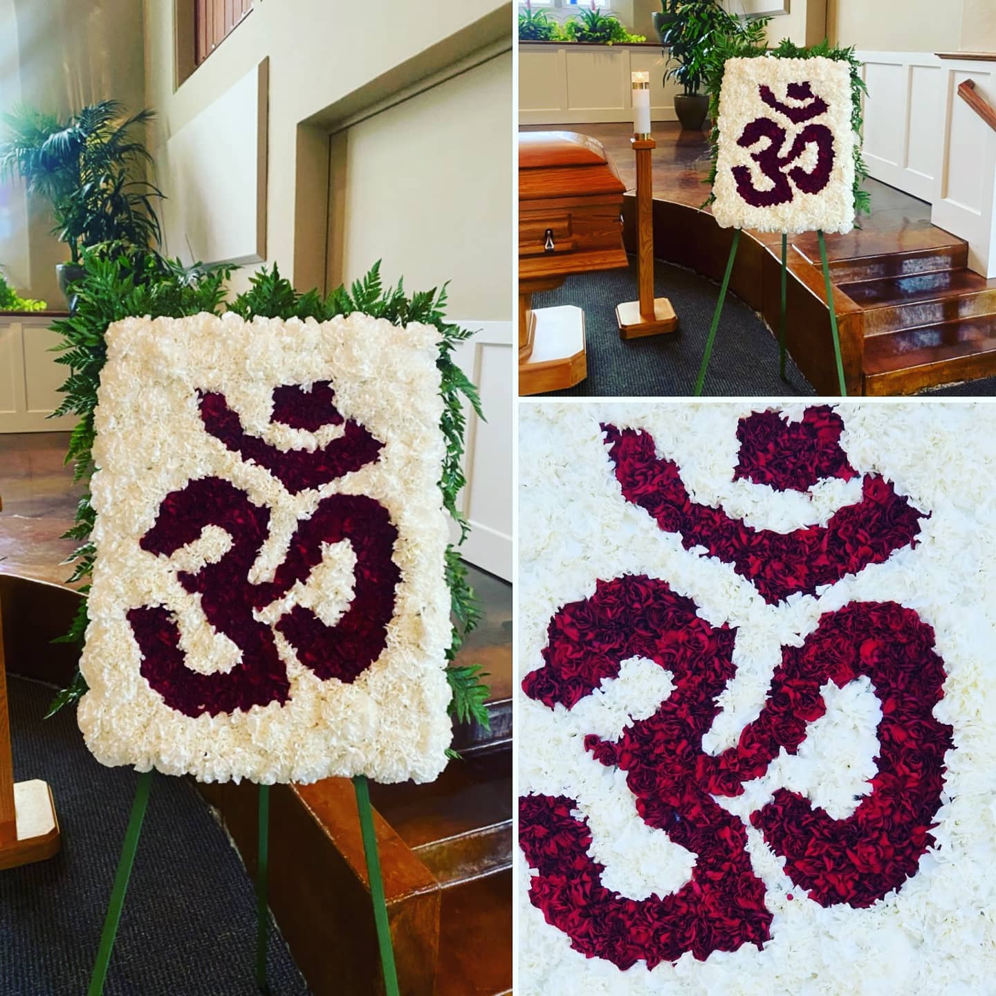 Flower arrangement with a purple symbol on a white background, displayed on an easel indoors, with plants and furniture nearby.