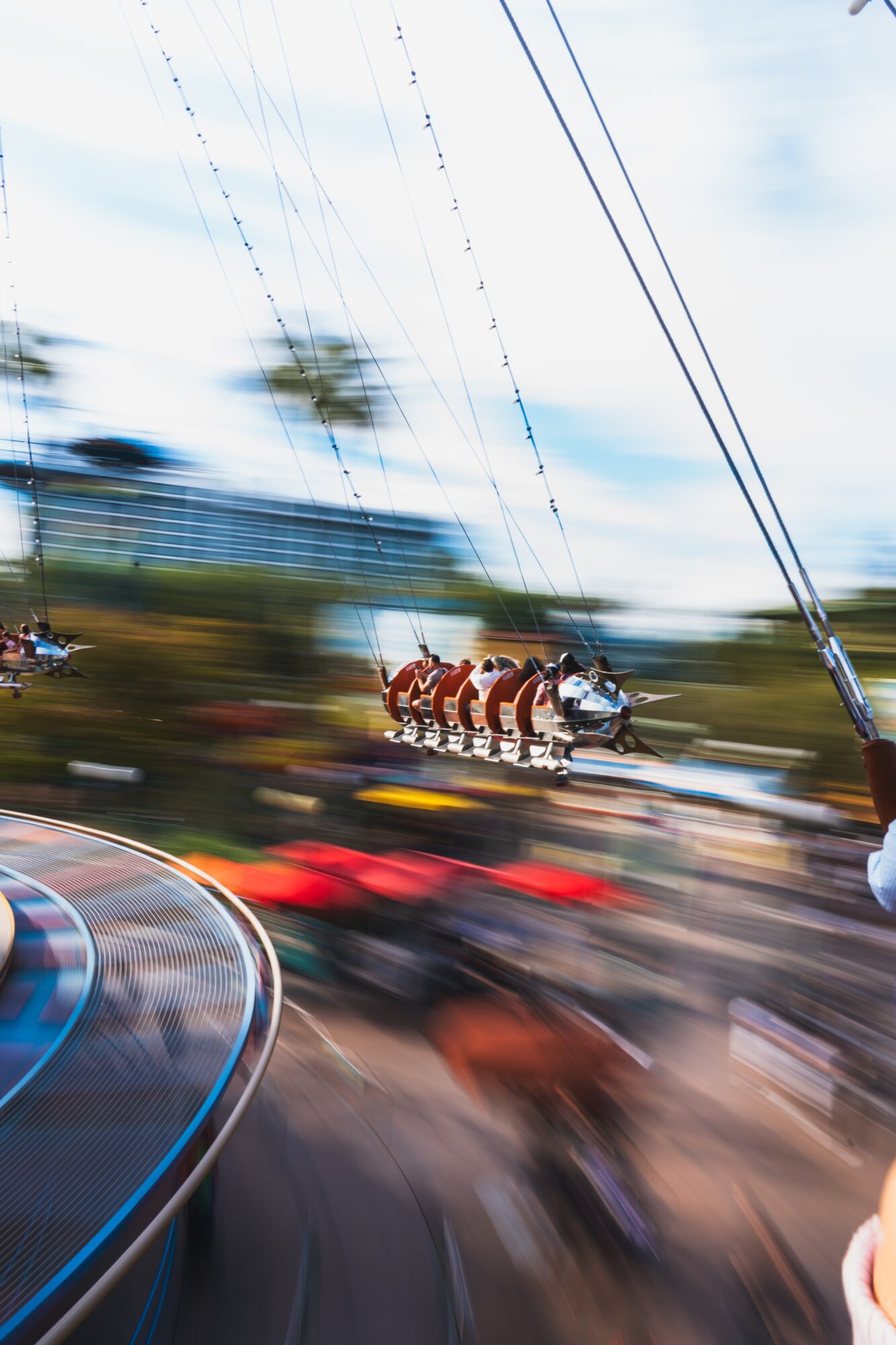 A carousel with horses and a person riding a motorcycle, with blurred background and motion effect.