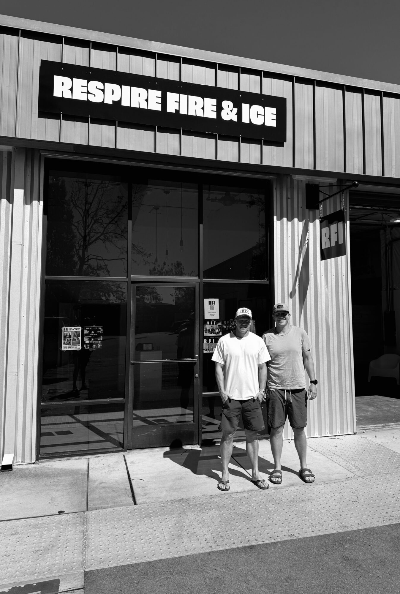 Two people stand outside a store with a sign reading 'RESPIRE FIRE & ICE' above the entrance.