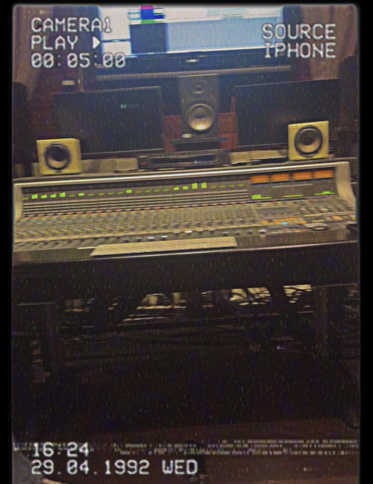 Recording studio mixing console with speakers and computer monitor, timestamped 1992, viewed from the side.