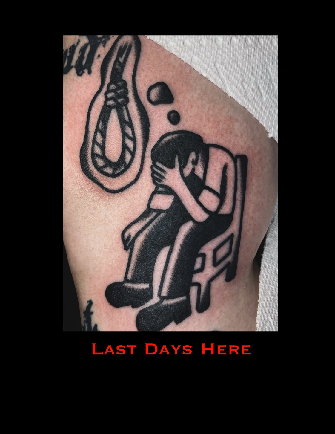 Tattoo of a person sitting with head in hands, thinking, with a noose hanging above. Text reads 'LAST DAYS HERE'.
