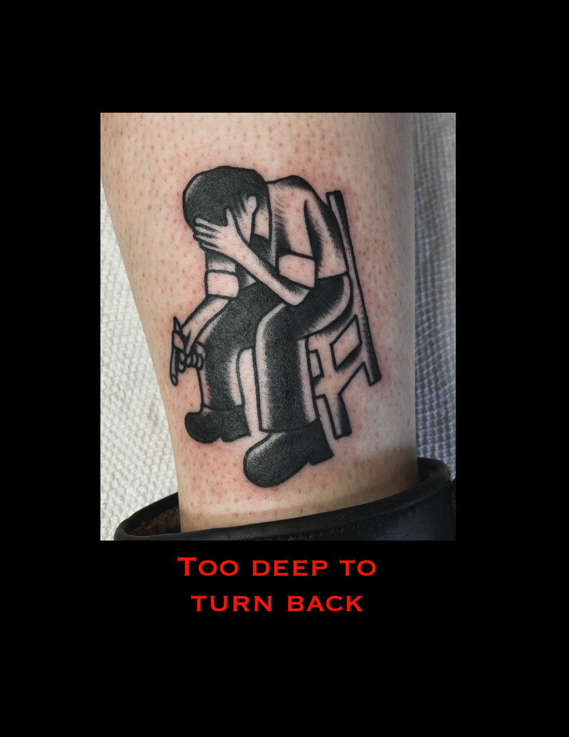 Tattoo of a person sitting on a chair with head in hands, with red text below reading 'Too deep to turn back'.