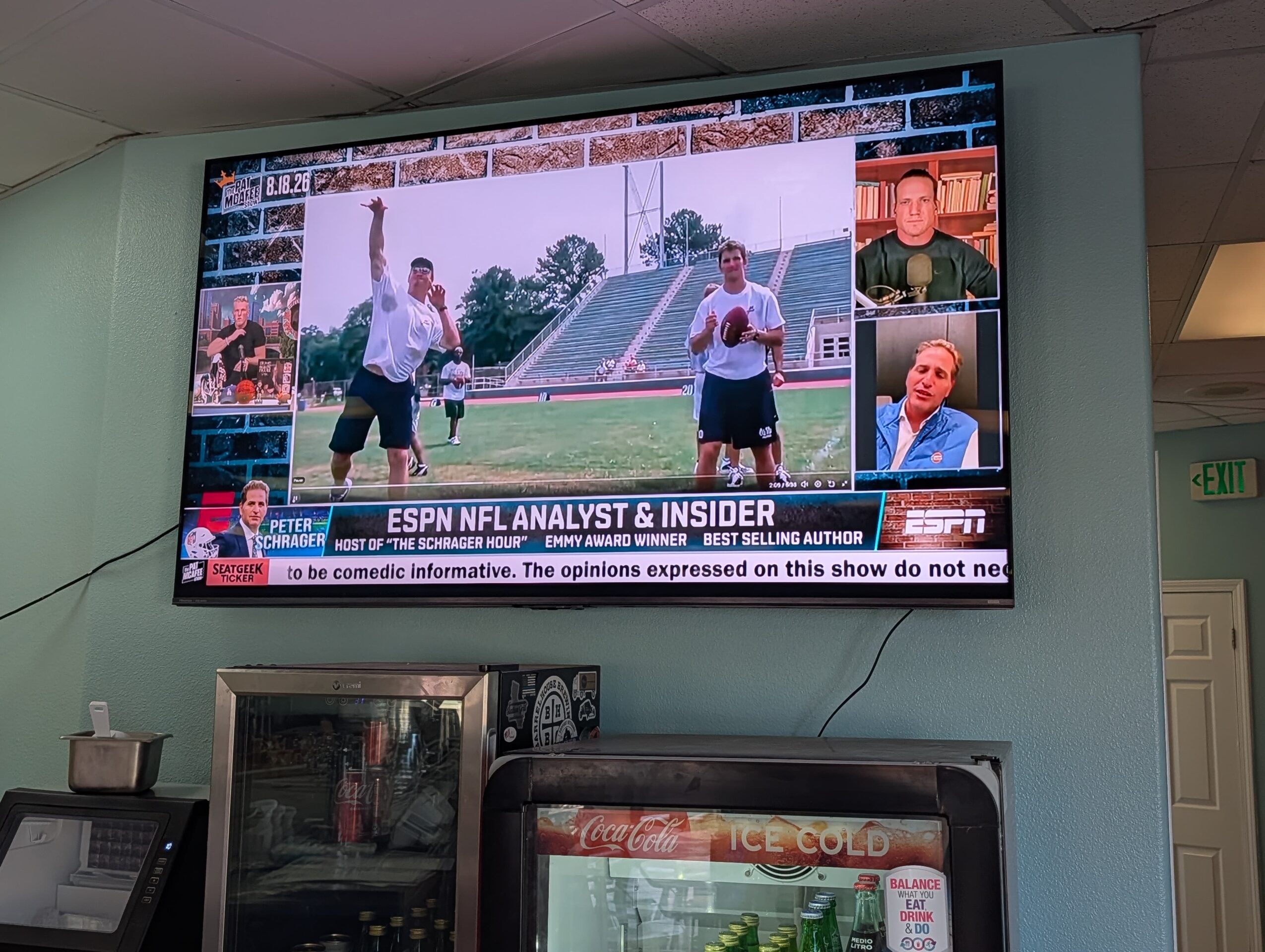 Television screen showing two people on a sports field, with smaller inset images of three other people, and a news ticker at the bottom.