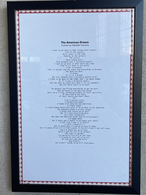Framed document titled 'The American Dream' with text inside, decorative border, and black frame.