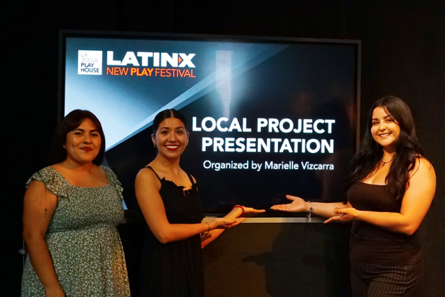 Three women standing in front of a screen displaying 'LATINX New Play Festival' and 'Local Project Presentation,' smiling and holding a plaque.