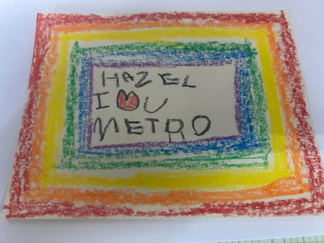 Colorful rainbow border surrounds handwritten message with a heart symbol, on a white background.