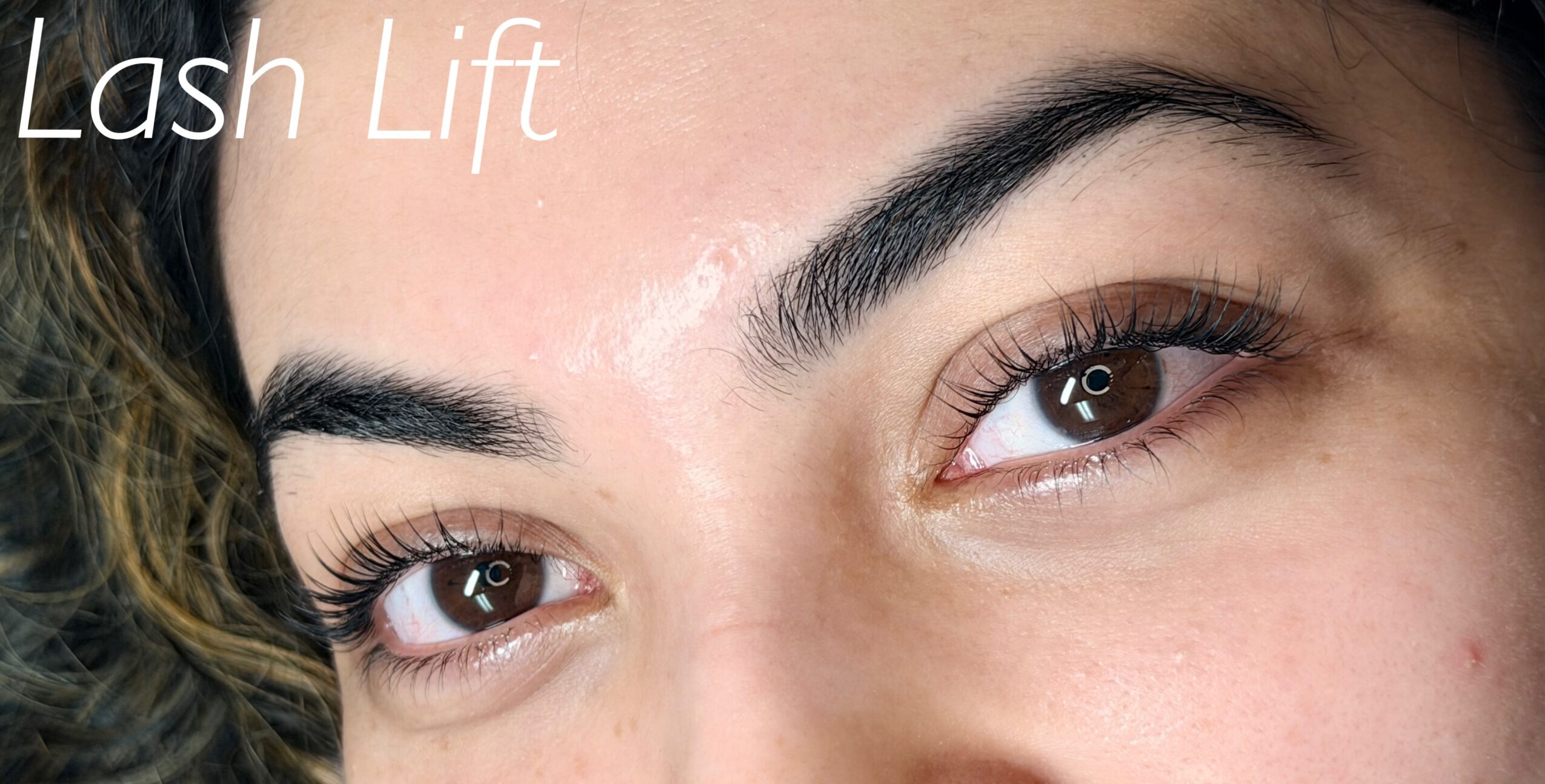 Close-up of a woman's eyes and eyebrows with the text 'Lash Lift' in the top left corner.