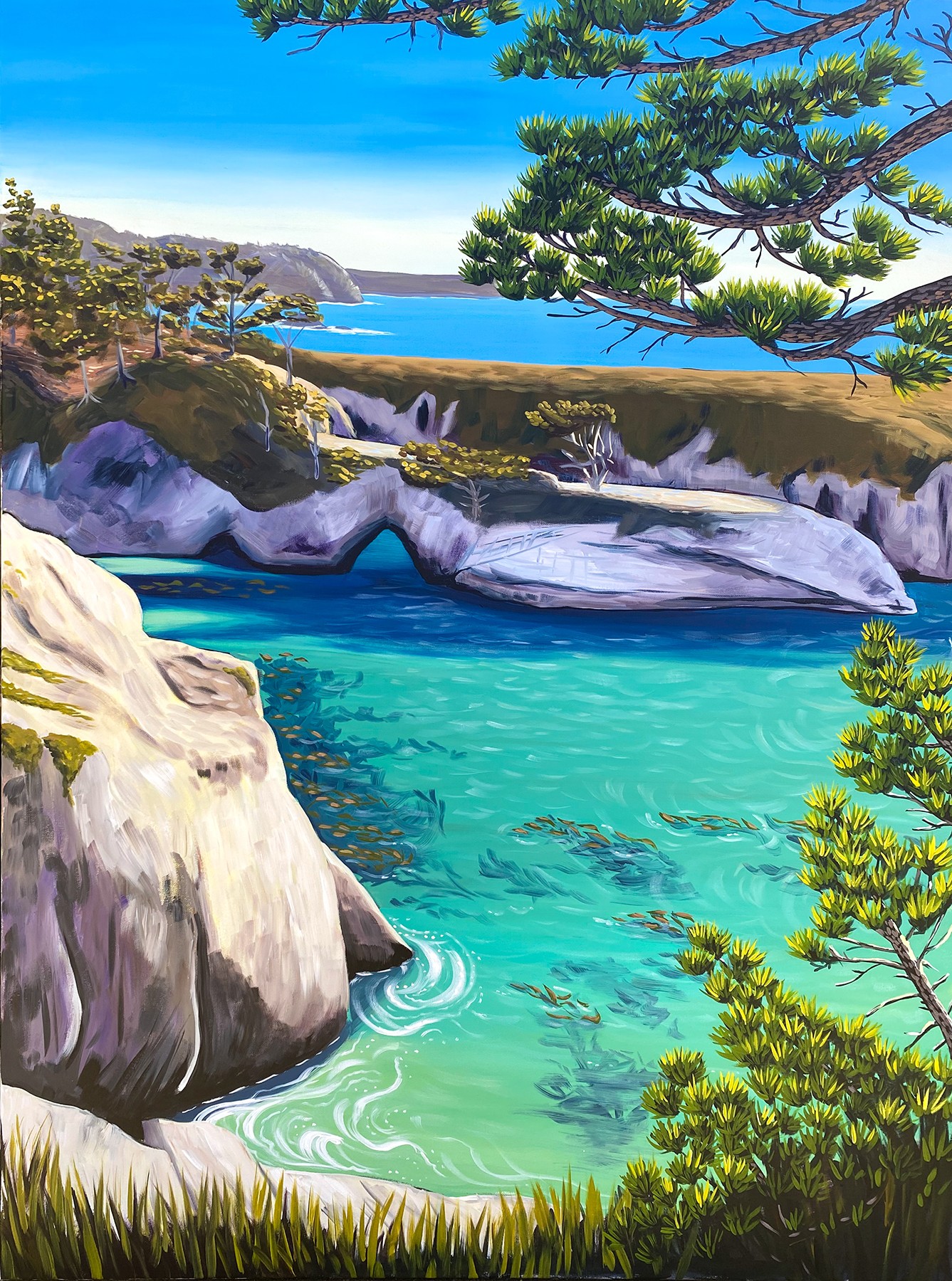 Scenic landscape with turquoise water, rocks, trees, and a distant shoreline under a blue sky.