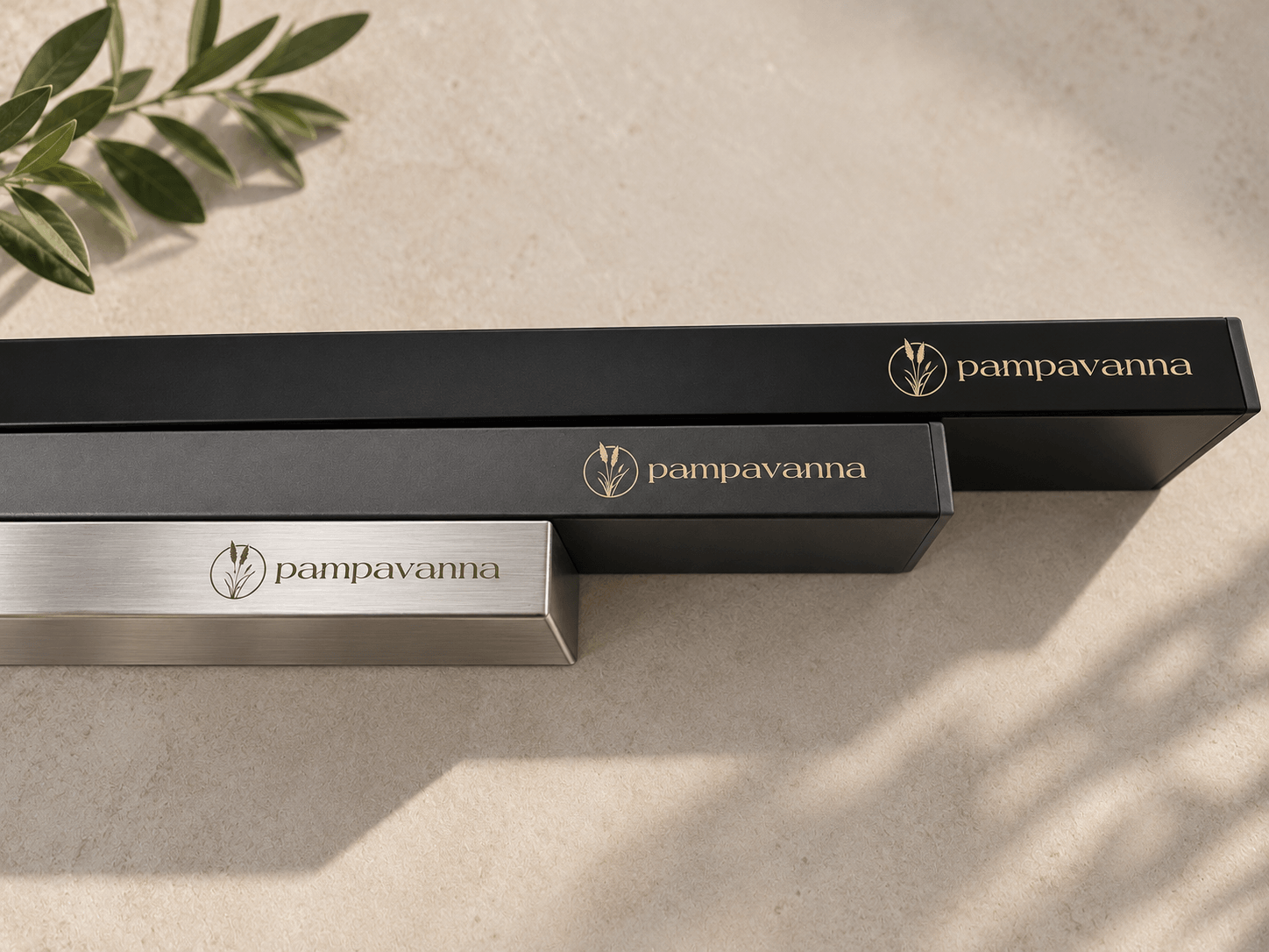 Three rectangular boxes with the brand name 'pampavanna' in different sizes and colors on a light surface with a shadow.