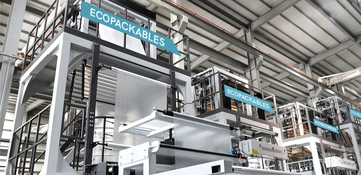 Industrial machinery and equipment in a factory setting with signs reading 'ECO PACK CABLES'.