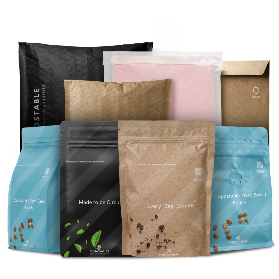 Assorted biodegradable plant-based compostable bags in various colors and sizes, some with printed text and logos.