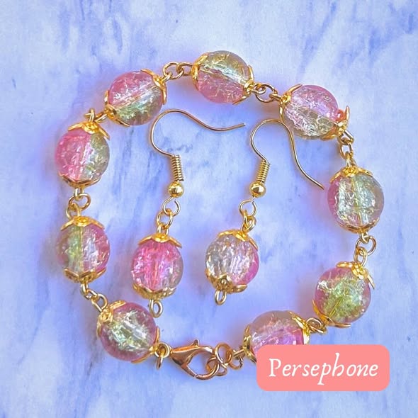 Pink and gold beaded jewelry set with bracelet and earrings on a light background, labeled Persephone.