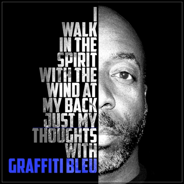 Half of a man's face with text on the left side, including a quote and graffiti blue text, on a black background.