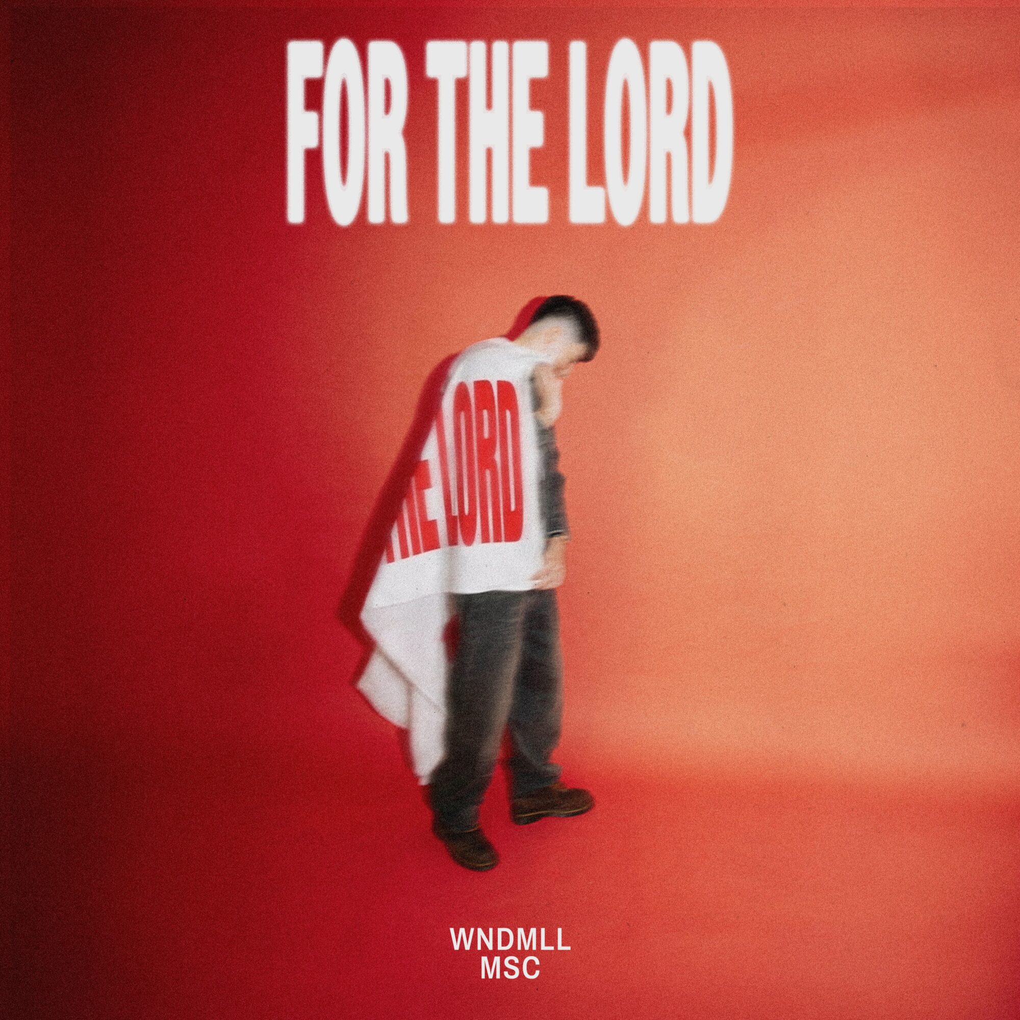 Person standing with a cloth draped over shoulders, text 'FOR THE LORD' above, red background, text 'WNDMLL MSC' below.
