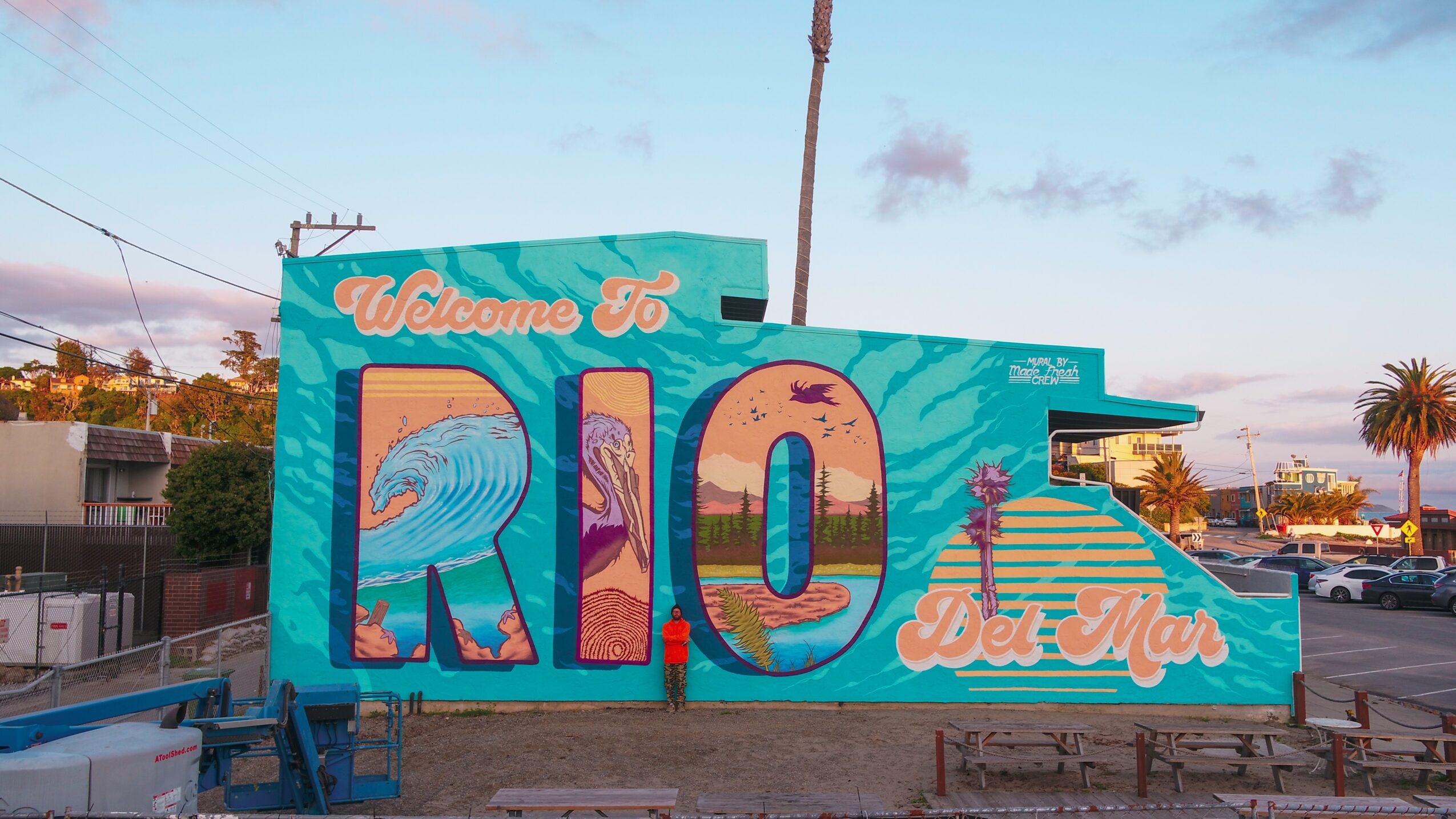 Colorful mural with large letters spelling 'RIO' and smaller text 'Welcome To' and 'Del Mar' on a building.