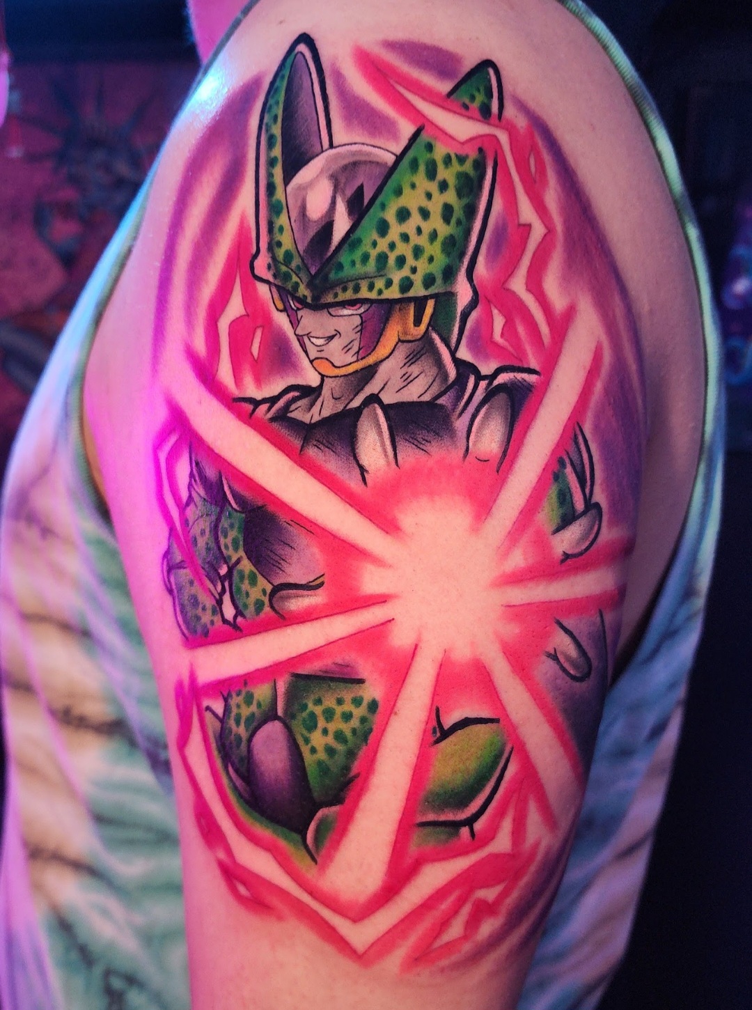 Tattoo of a character with green and purple armor, surrounded by pink and red energy lines.
