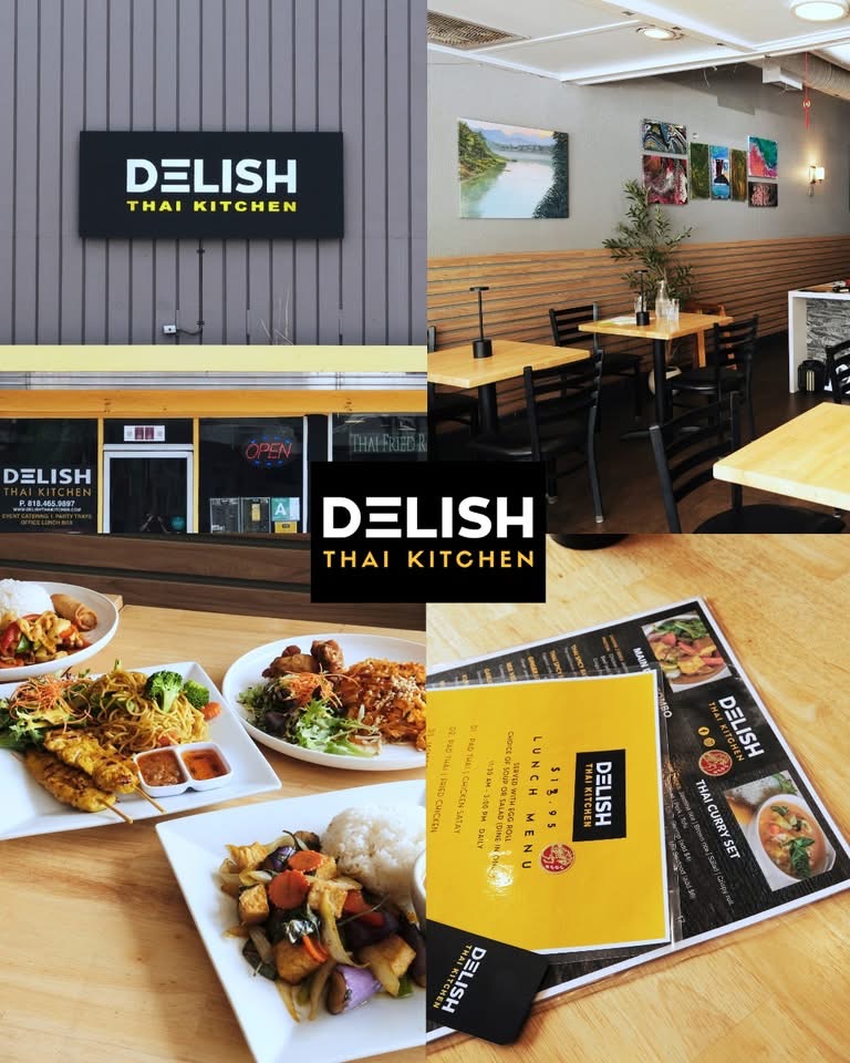 Interior of Thai restaurant with seating area, menu, and a sign reading 'Delish Thai Kitchen'. Food dishes are displayed on a table.
