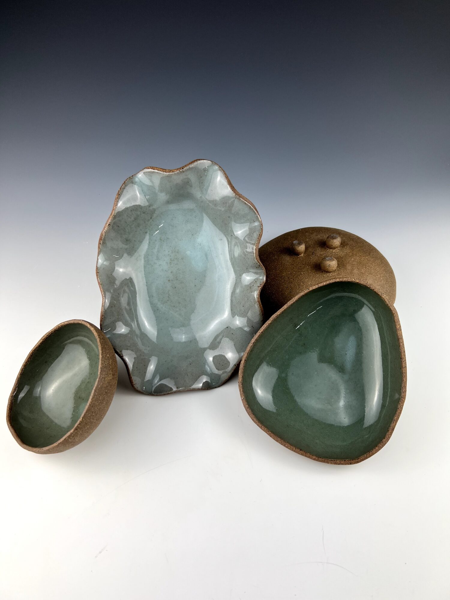 Four decorative stones with smooth, polished surfaces and earthy tones, arranged on a gradient background.